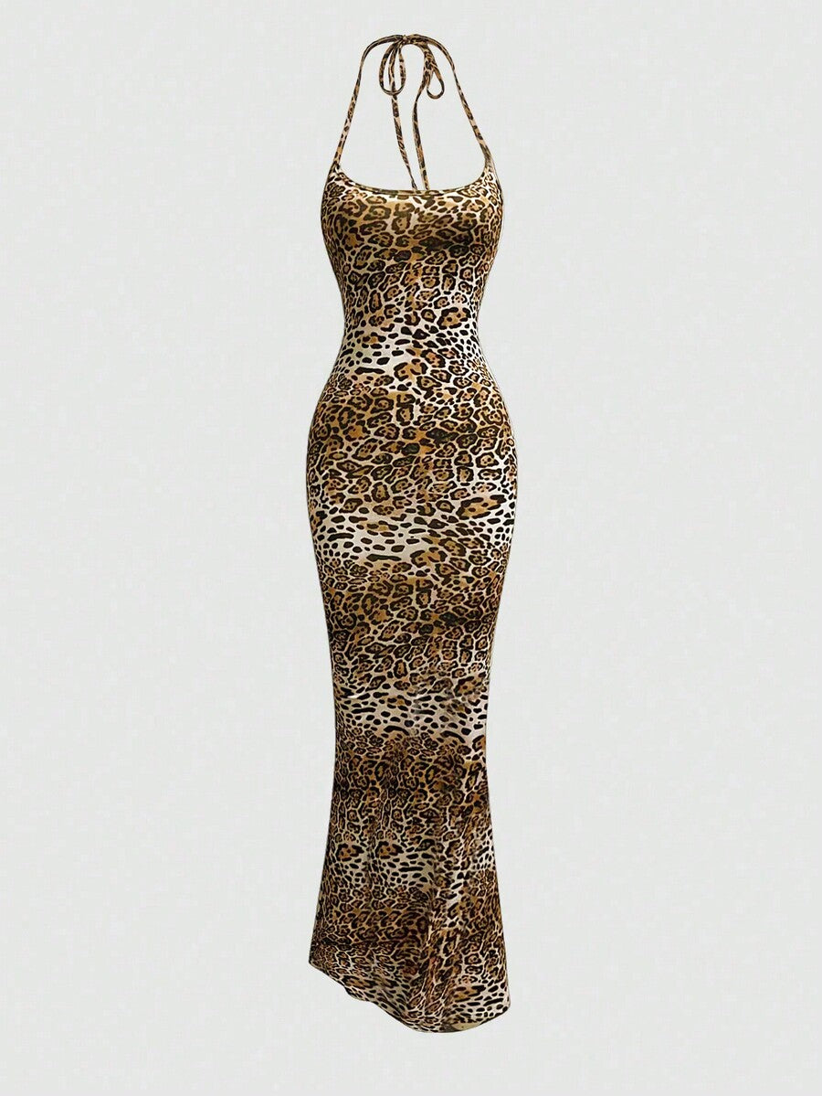 Women wearing a sleeveless leopard print halter neck maxi bodycon dress with a side slit