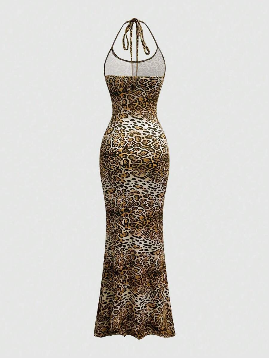Women wearing a sleeveless leopard print halter neck maxi bodycon dress with a side slit