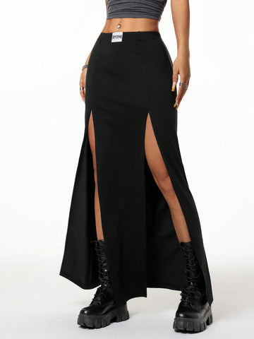 Women's black high waist long skirt with split thigh slit, zipper, and letter patch detail made from knitted stretch fabric.
