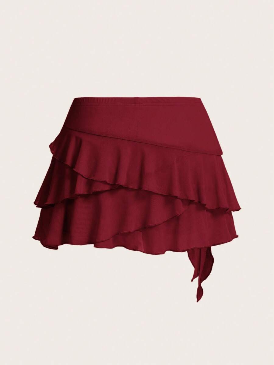 White tiered ruffle trim mini skirt for women with low waist, knot detail, mesh fabric, and casual Y2K boho design.