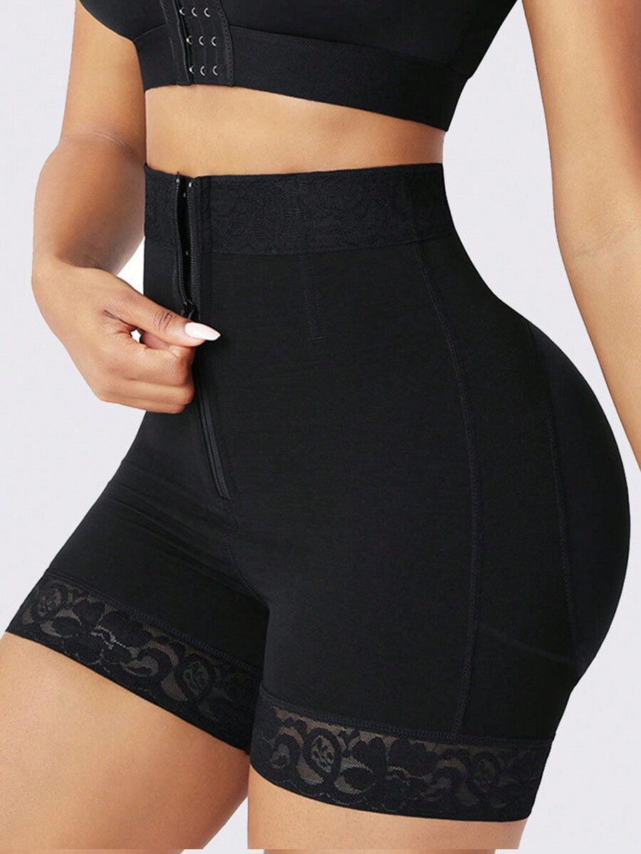 Black high waist butt lifting shapewear shorts made from mesh fabric with contrast lace trim and a front zipper for tummy and thigh shaping.