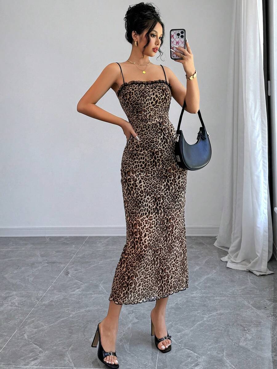 Women wearing a brown leopard print midi cami dress with spaghetti straps, backless detail, and a side split thigh.