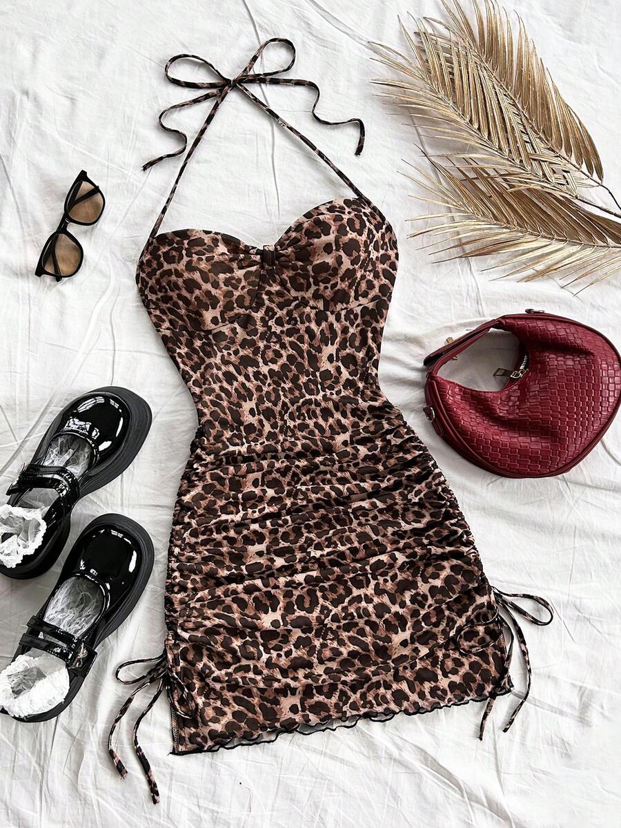 Multicolor leopard print sleeveless halter mini dress for women featuring a backless design, ruched drawstring hem, and slim fit.