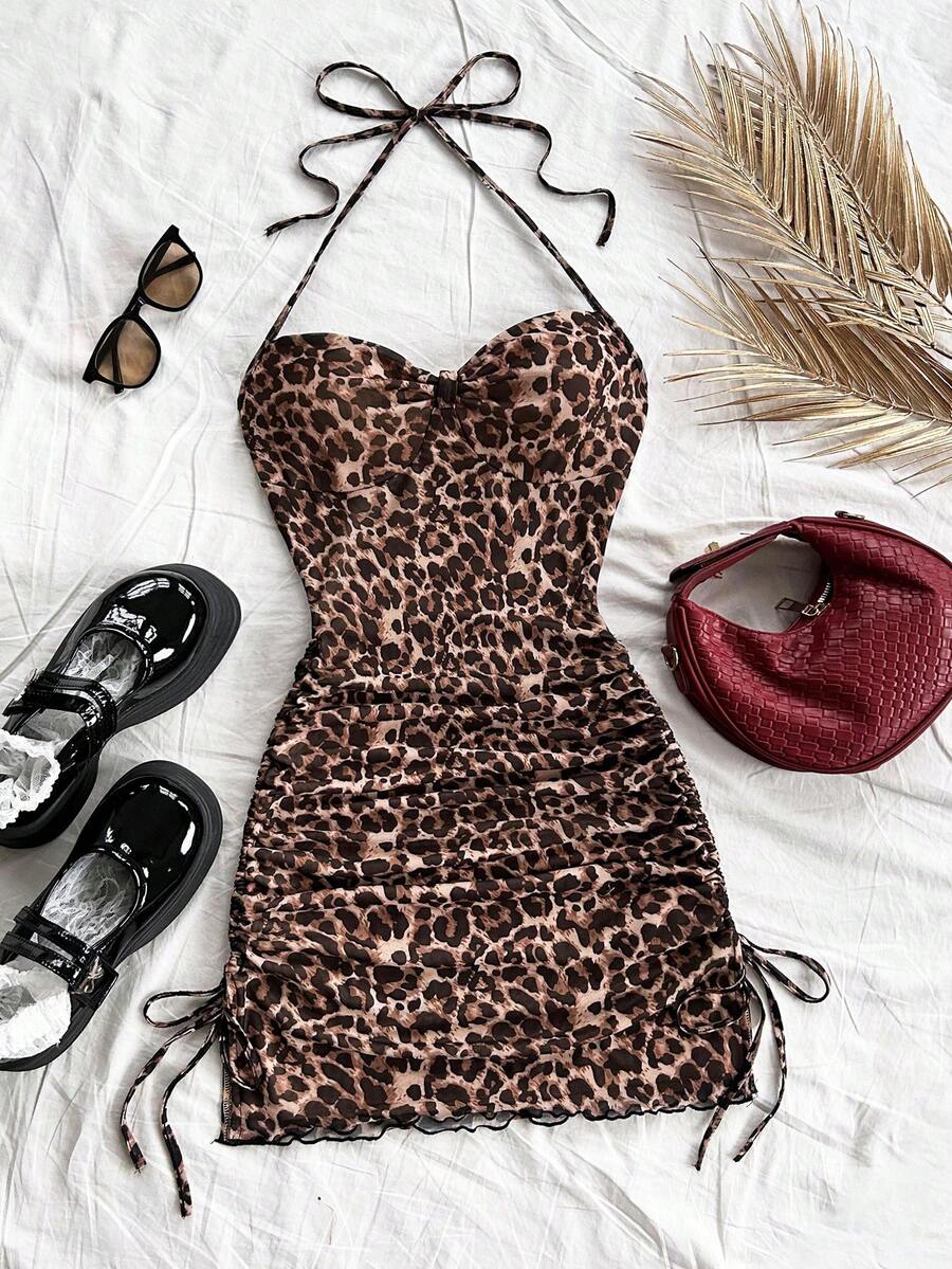 Multicolor leopard print sleeveless halter mini dress for women featuring a backless design, ruched drawstring hem, and slim fit.
