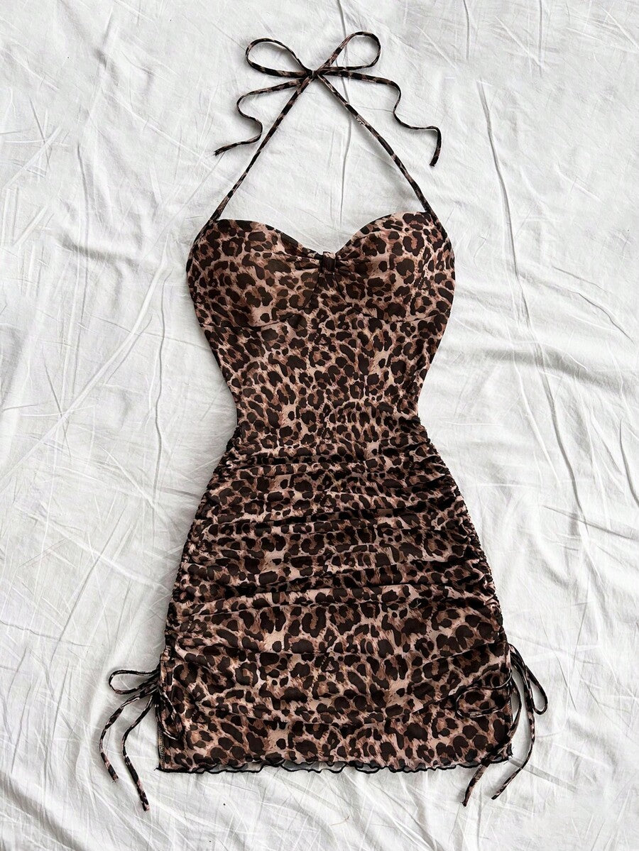 Multicolor leopard print sleeveless halter mini dress for women featuring a backless design, ruched drawstring hem, and slim fit.