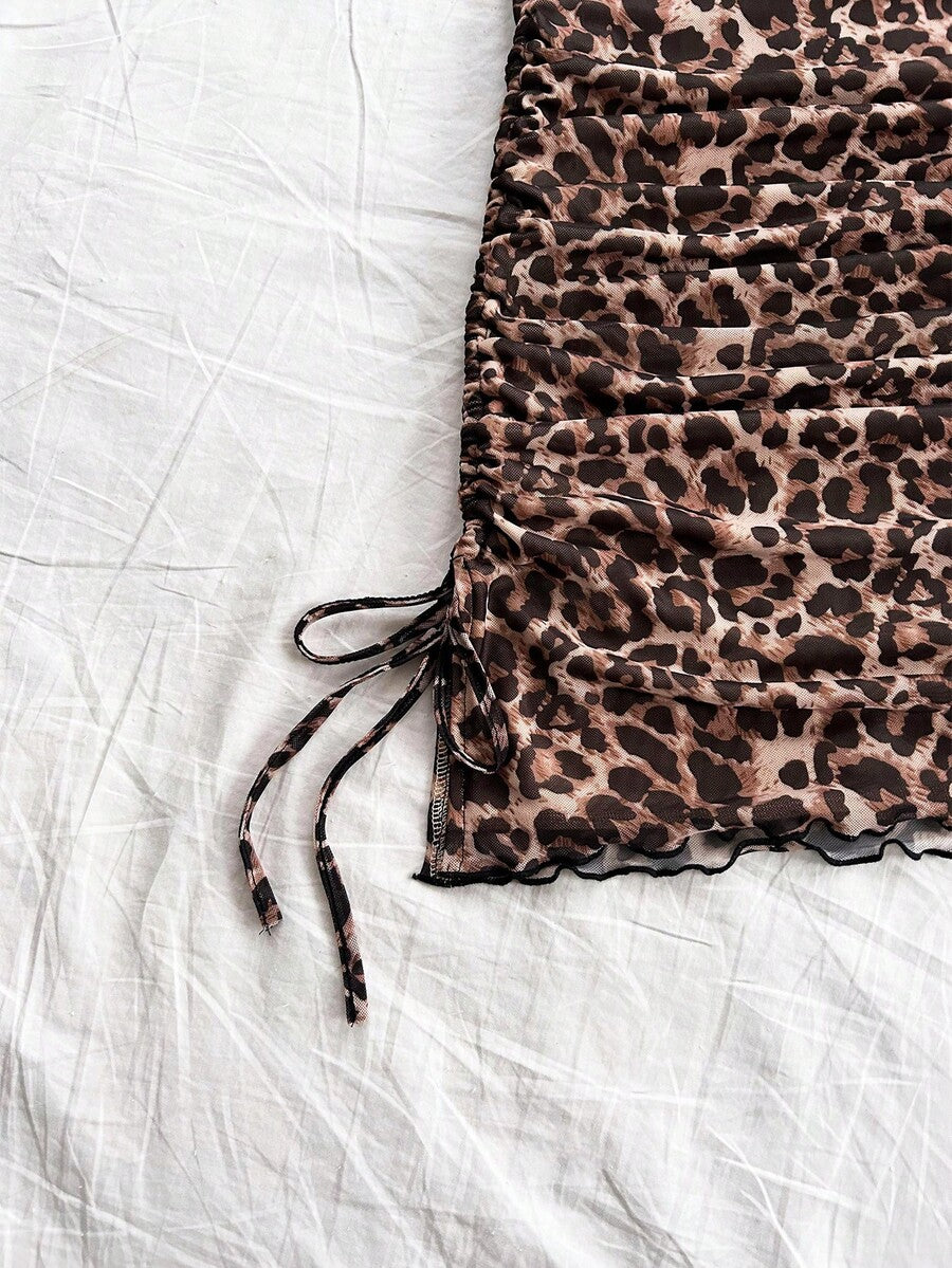Multicolor leopard print sleeveless halter mini dress for women featuring a backless design, ruched drawstring hem, and slim fit.