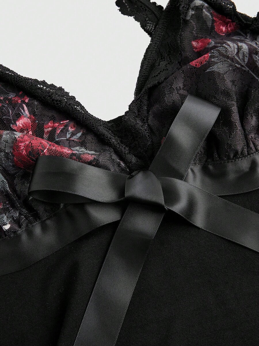 Women's black crop camisole top with rose pattern contrast lace, deep V-neck, and wide shoulder straps.