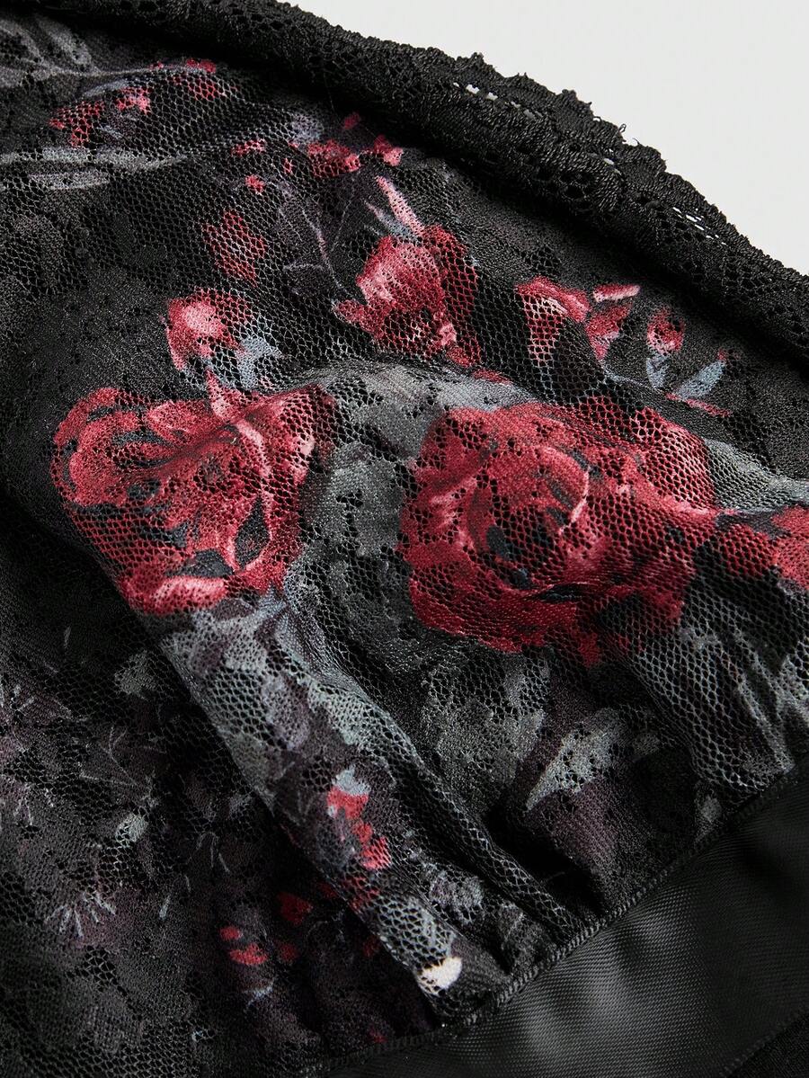 Women's black crop camisole top with rose pattern contrast lace, deep V-neck, and wide shoulder straps.