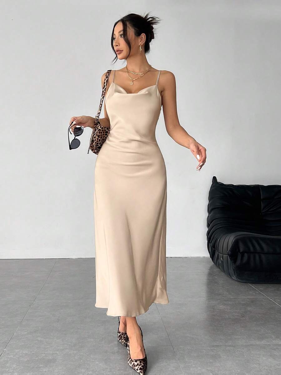 Women's long apricot satin cami dress featuring a draped swing collar, spaghetti straps, backless zipper back, and mermaid hem.