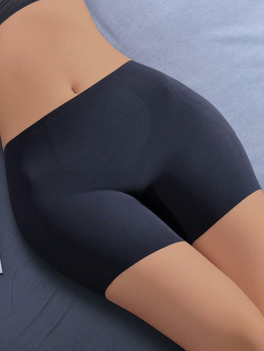 Women's apricot seamless padded shapewear panties featuring tummy control design and teardrop foam padding.