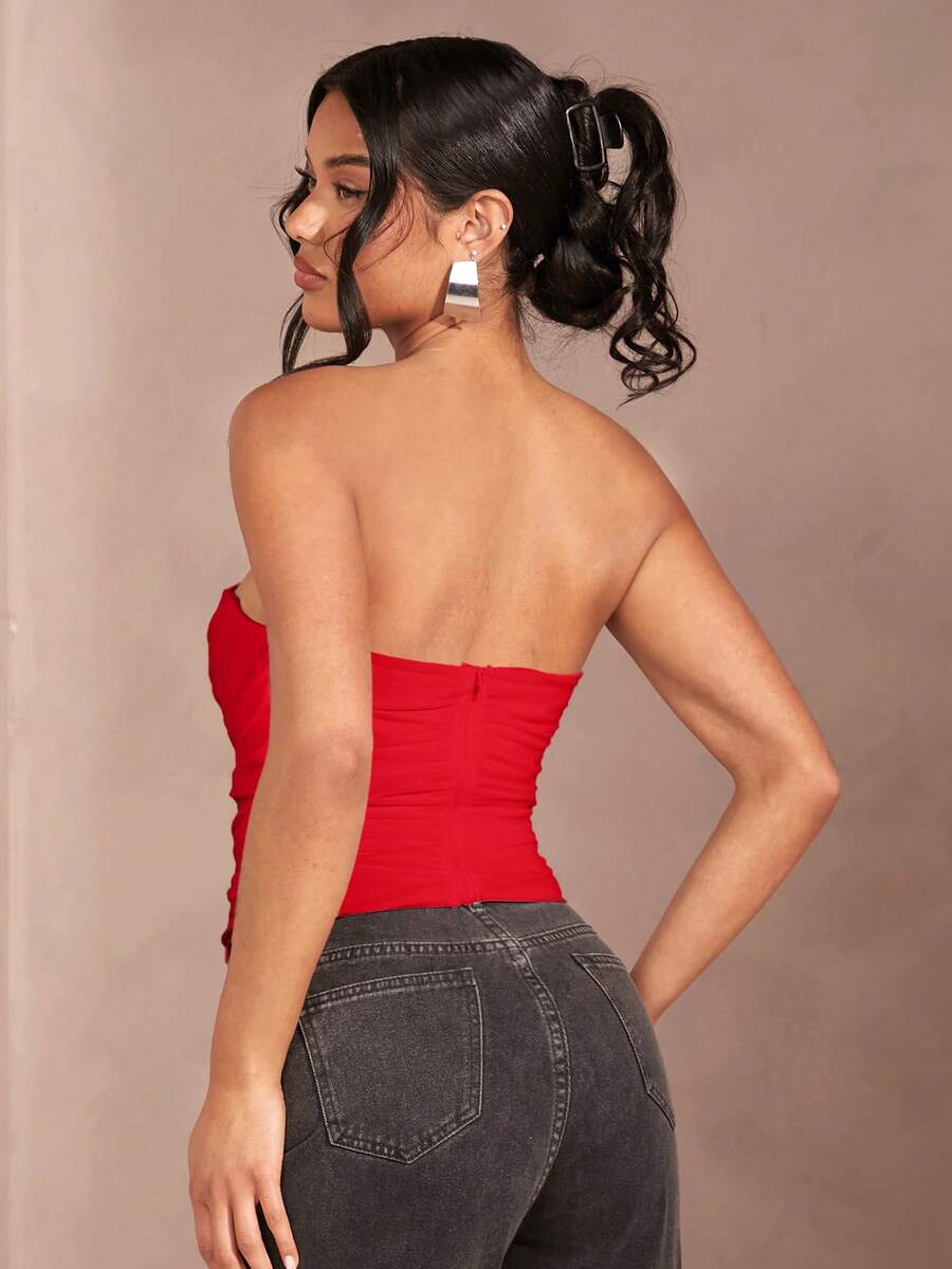 Black strapless corset crop top with asymmetrical lace-up ruched detailing and a slim fit for women.