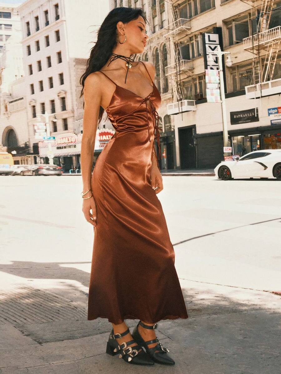 Women's coffee brown satin slip dress featuring spaghetti straps, a backless criss-cross knot design, high waist, and a side slit long hem.