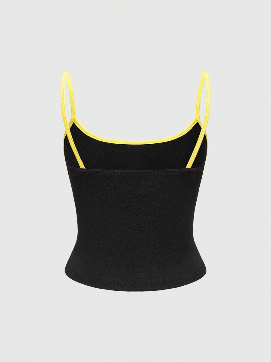 Black ribbed cropped cami top featuring a white bat graphic print on the front with spaghetti straps and contrast binding trim.