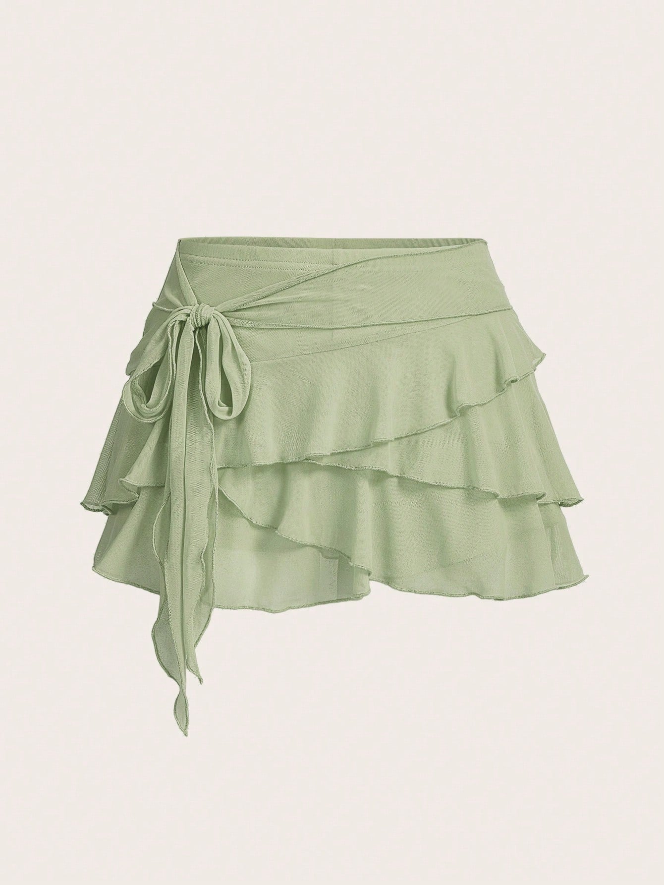 White tiered ruffle trim mini skirt for women with low waist, knot detail, mesh fabric, and casual Y2K boho design.