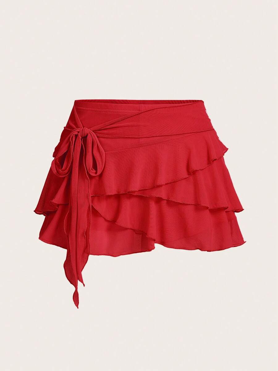 White tiered ruffle trim mini skirt for women with low waist, knot detail, mesh fabric, and casual Y2K boho design.