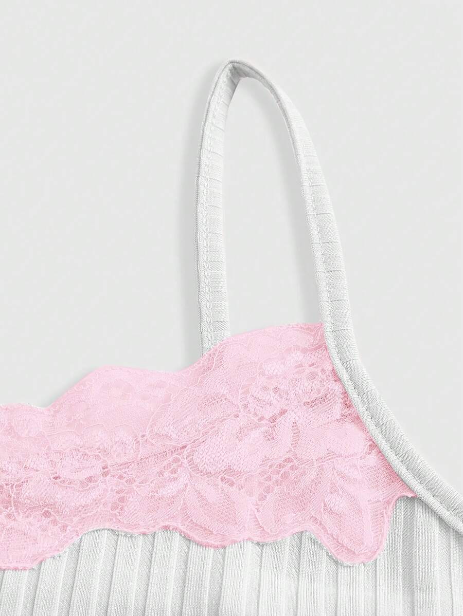 Women's black rib-knit cami top featuring delicate contrast lace trim and thin spaghetti straps.