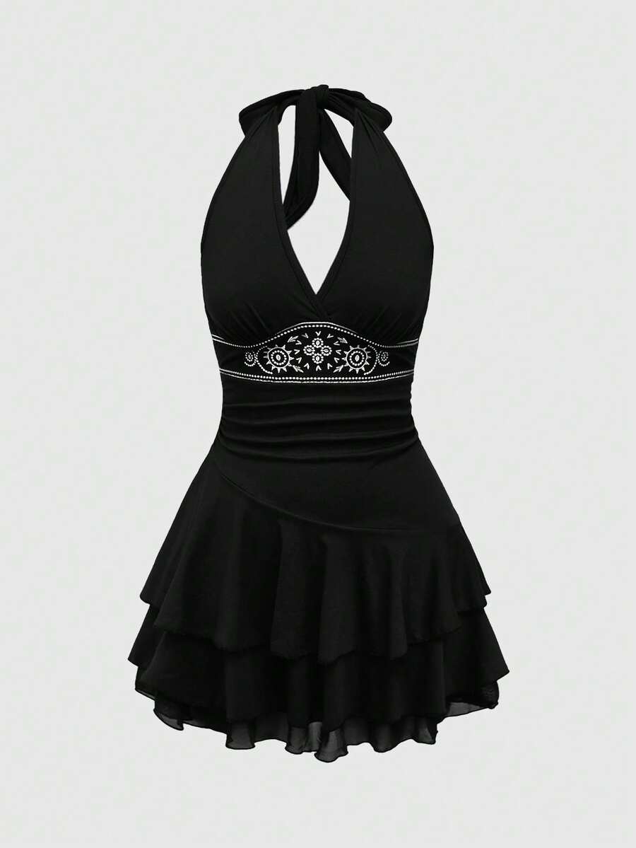 Women's sun totem embroidered sleeveless layered mini dress featuring a halter neck, backless tie back design, and slim fit high-waist A-line silhouette.