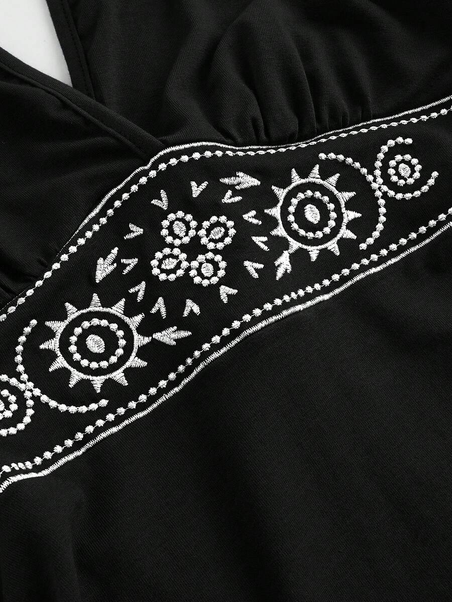 Women's sun totem embroidered sleeveless layered mini dress featuring a halter neck, backless tie back design, and slim fit high-waist A-line silhouette.