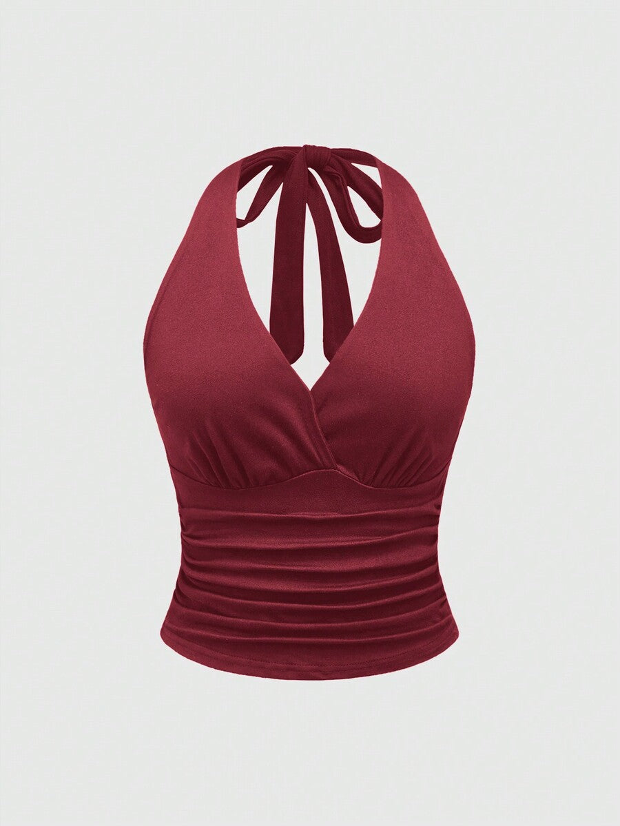 Women's halter crop tank top featuring a backless silhouette and ruched detailing in a slim fit design.