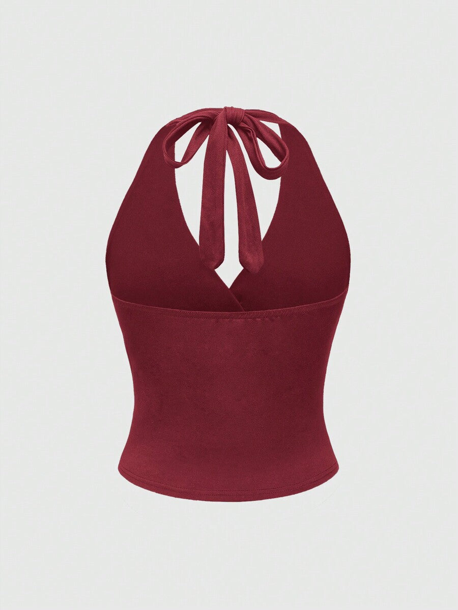 Women's halter crop tank top featuring a backless silhouette and ruched detailing in a slim fit design.