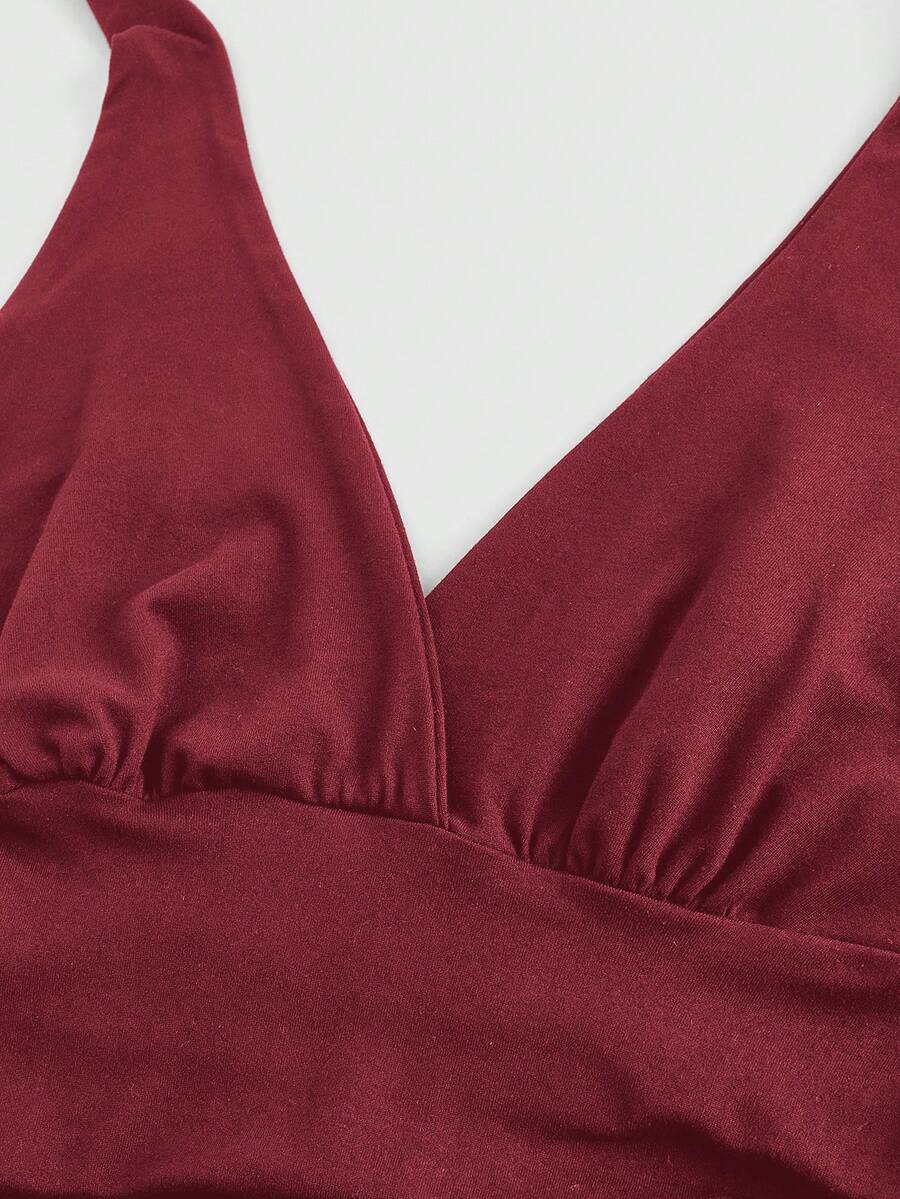 Women's halter crop tank top featuring a backless silhouette and ruched detailing in a slim fit design.