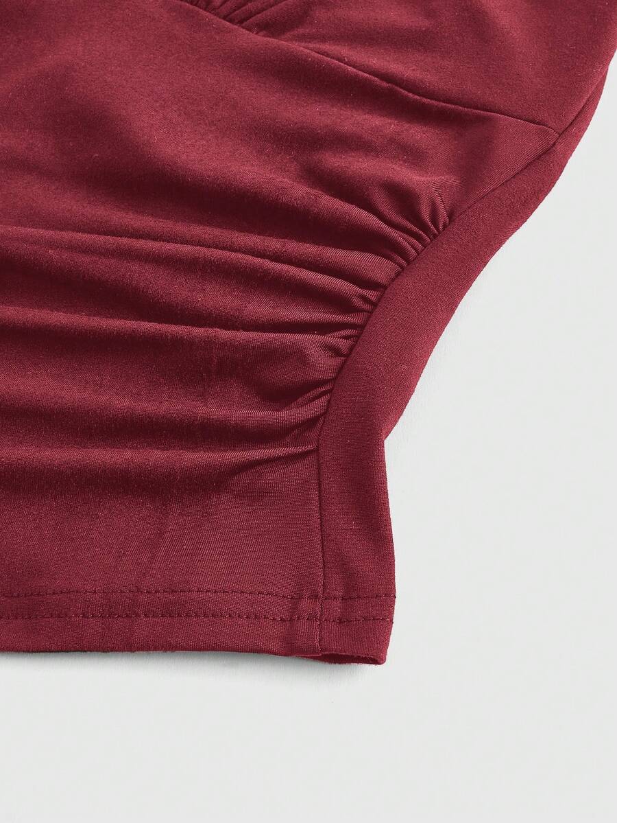 Women's halter crop tank top featuring a backless silhouette and ruched detailing in a slim fit design.