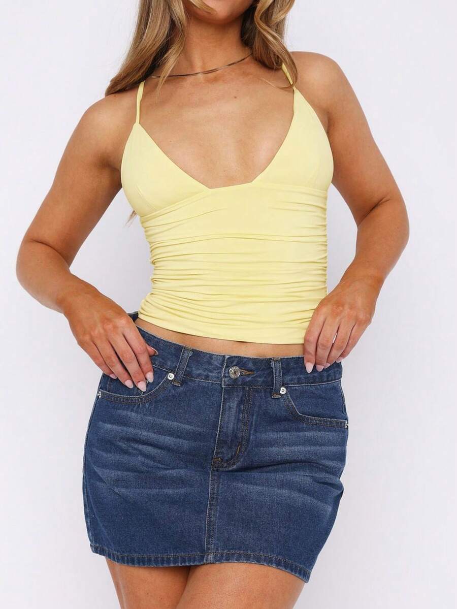Women's V-neck backless camisole crop top with ruched detailing in a slim fit knit fabric.