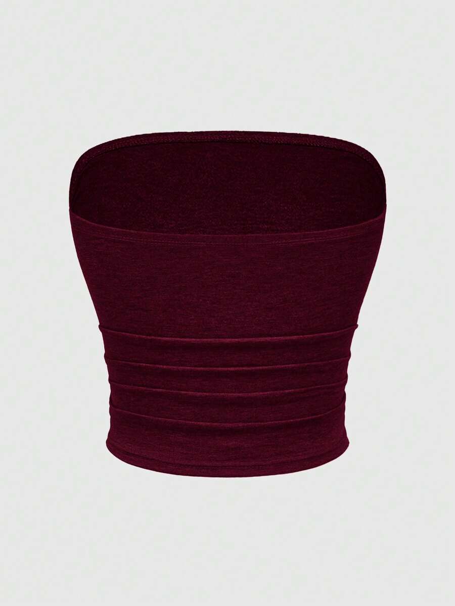 Women's strapless star print tube crop top featuring rhinestone details and ruched accents in burgundy knitted stretch fabric.