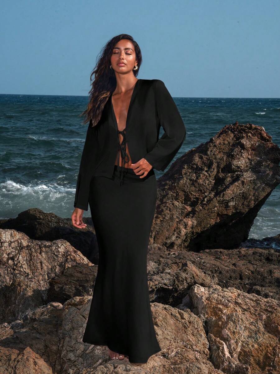 Women's black woven mermaid maxi skirt featuring a solid color design, mid waist, and 100% cotton fabric.