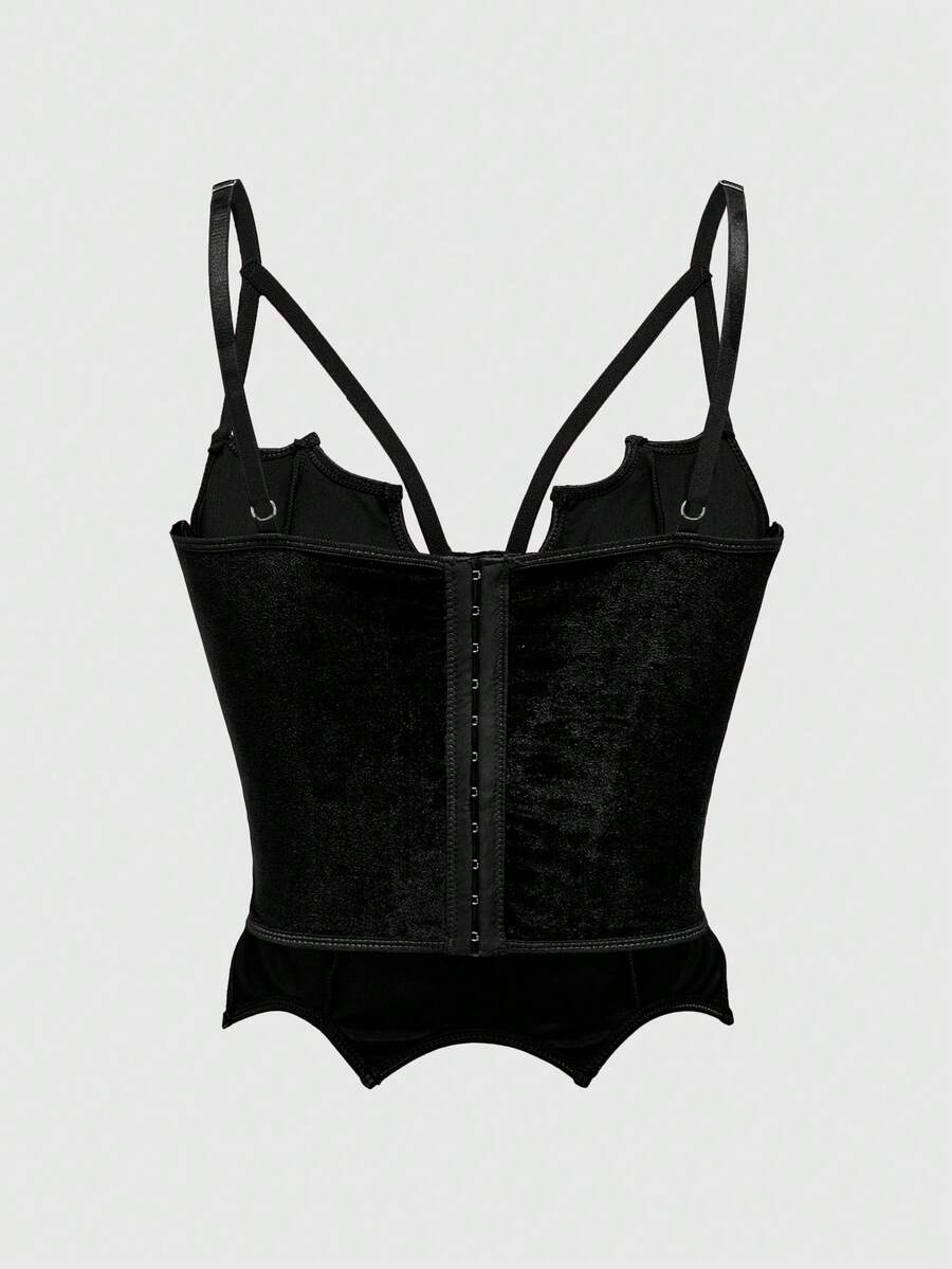 A women's black velvet crop camisole top featuring criss-cross shoulder straps, asymmetrical cut-out details, and a sleeveless vest neckline.