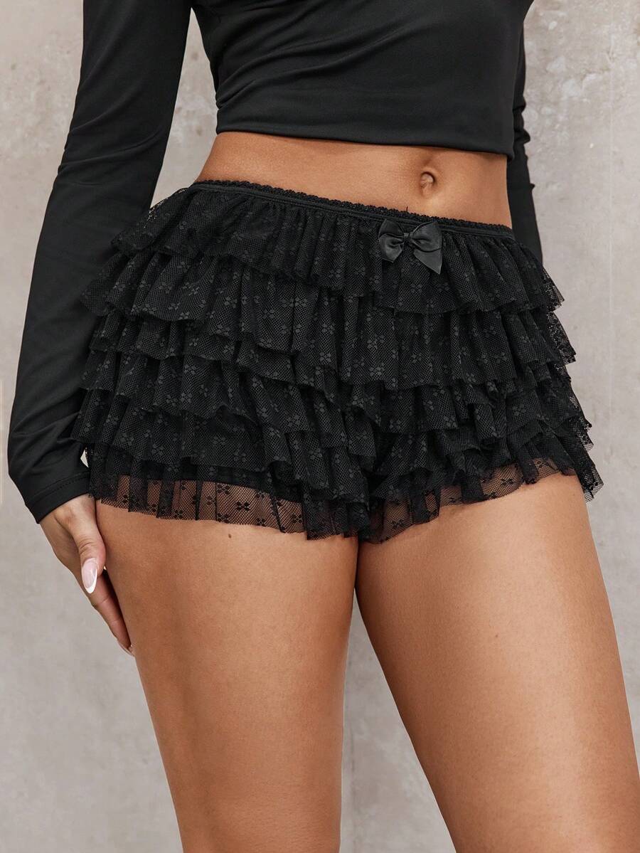 Apricot tiered lace ruffle hem low waist shorts for women featuring elastic waist and lined semi-sheer knit fabric.