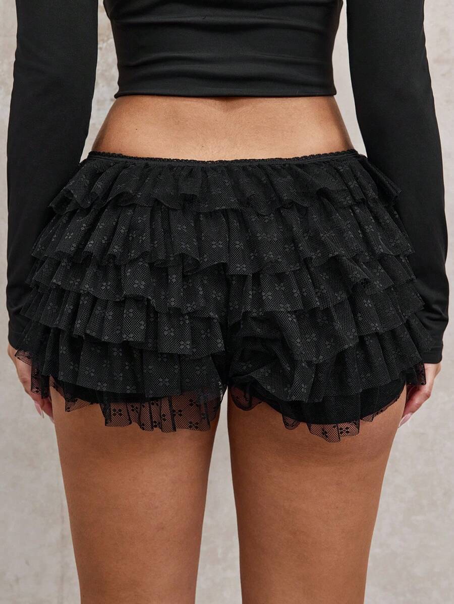 Apricot tiered lace ruffle hem low waist shorts for women featuring elastic waist and lined semi-sheer knit fabric.