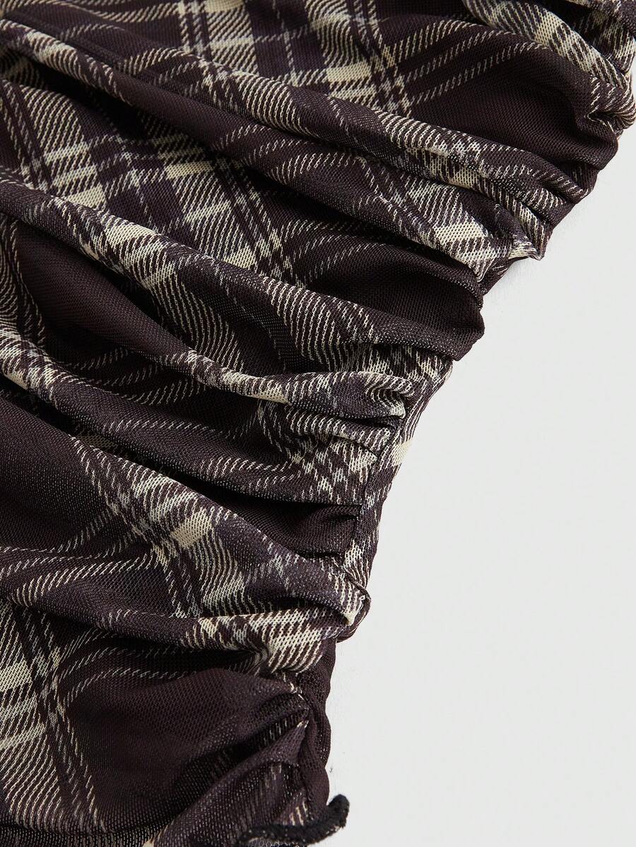 Women's black polka dot strapless tube top made of ruched mesh fabric featuring an asymmetrical hem and matching scarf.