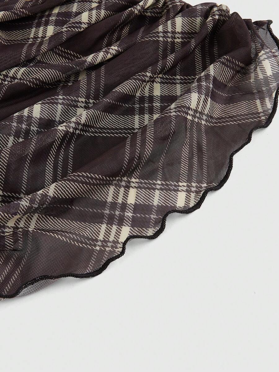 Women's black polka dot strapless tube top made of ruched mesh fabric featuring an asymmetrical hem and matching scarf.