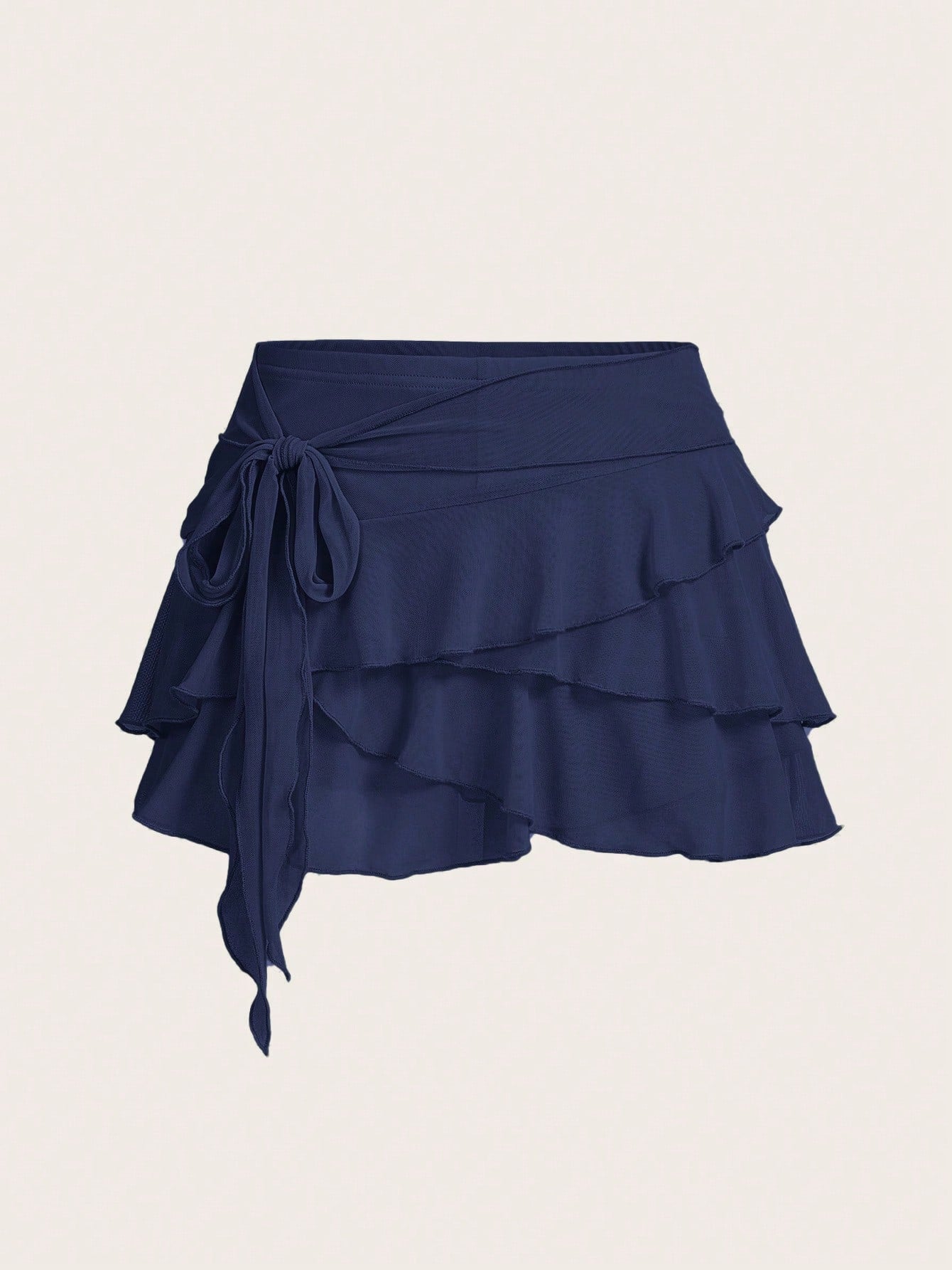 White tiered ruffle trim mini skirt for women with low waist, knot detail, mesh fabric, and casual Y2K boho design.