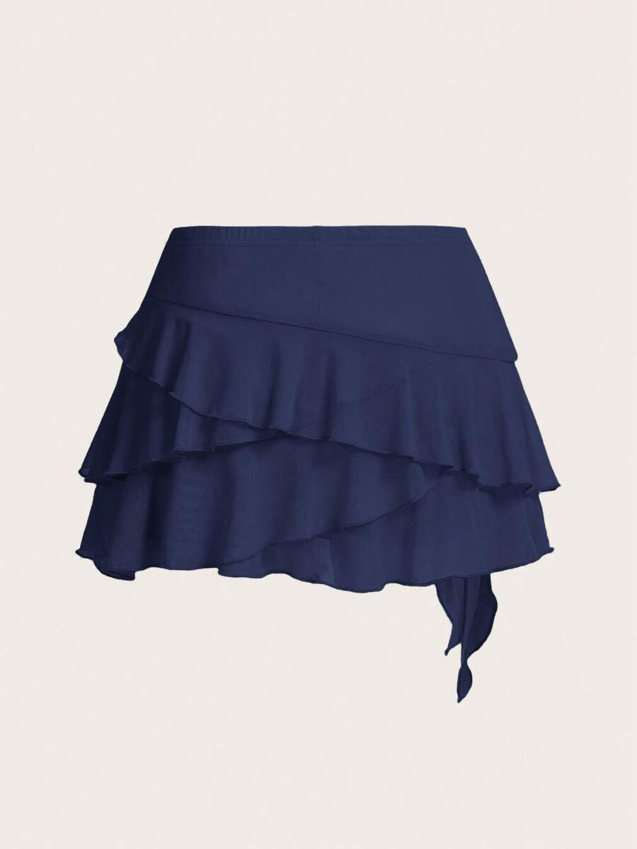 White tiered ruffle trim mini skirt for women with low waist, knot detail, mesh fabric, and casual Y2K boho design.