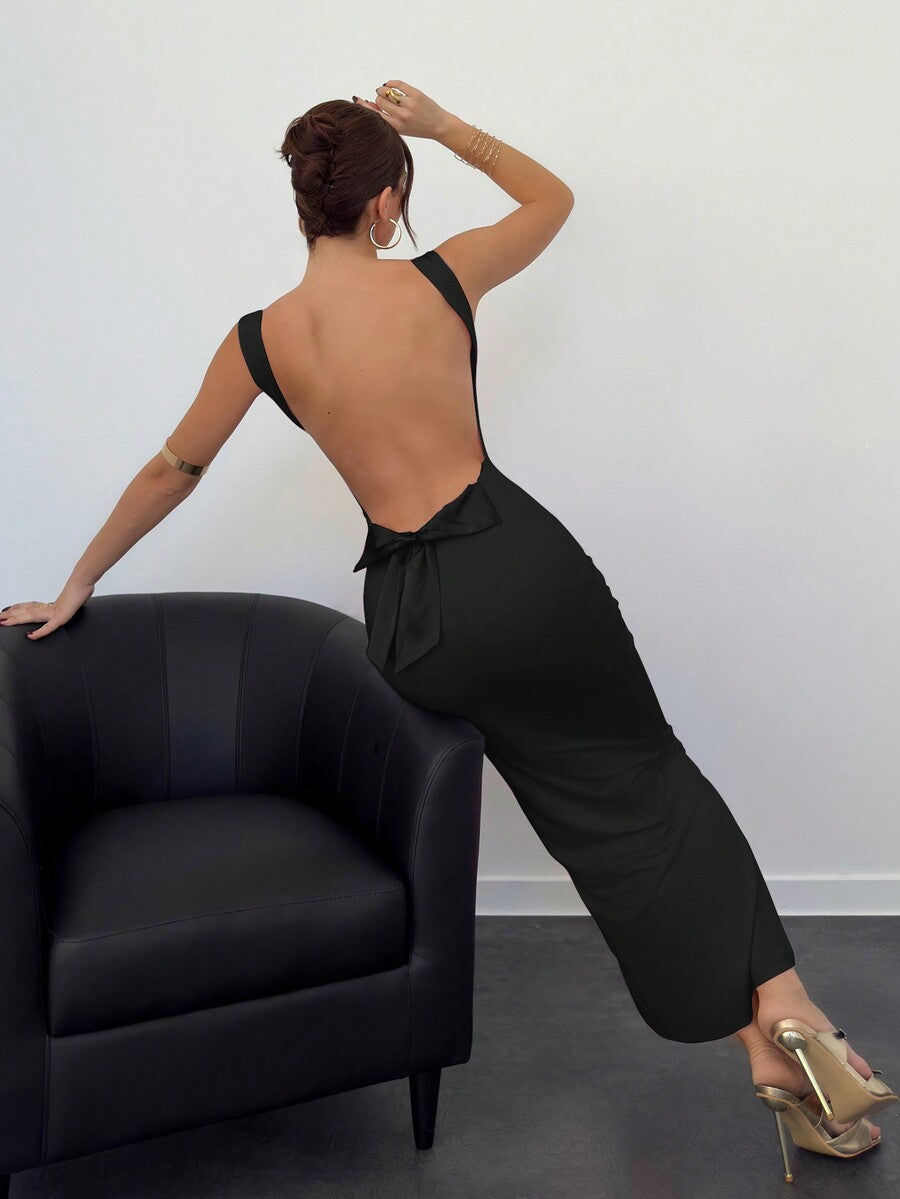Beige sleeveless backless cami maxi dress for women featuring bow decor, split hem, and slim fit knitted fabric.