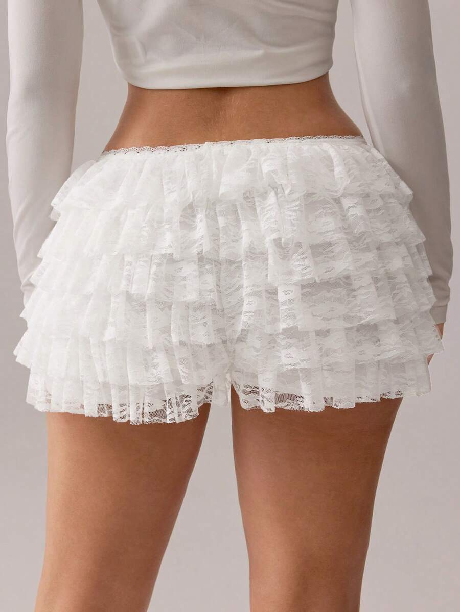 Apricot tiered lace ruffle hem low waist shorts for women featuring elastic waist and lined semi-sheer knit fabric.