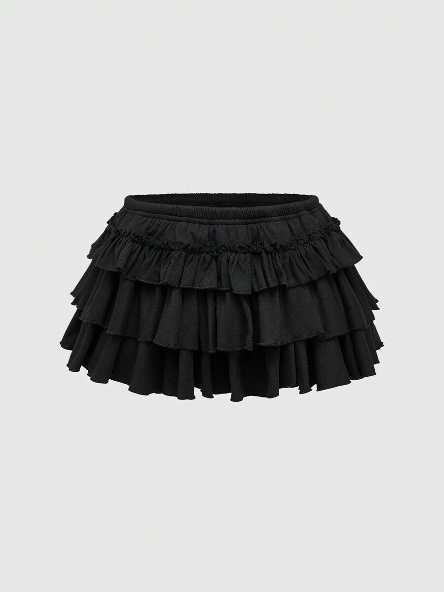 Black Y2K ultra low waist tiered ruffle mini skirt made of stretch knitted fabric for women.