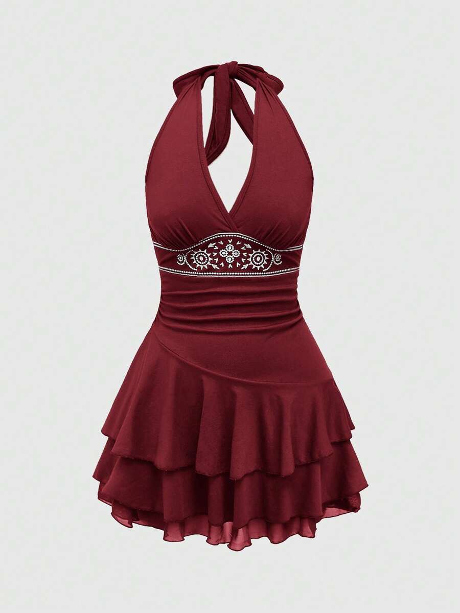 Women's sun totem embroidered sleeveless layered mini dress featuring a halter neck, backless tie back design, and slim fit high-waist A-line silhouette.