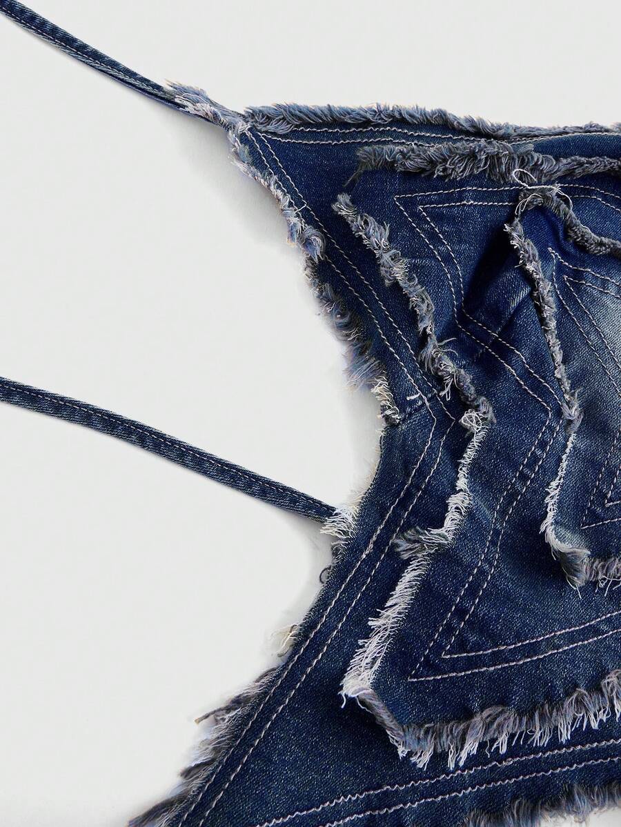 Blue denim halter tank top for women featuring distressed star patch detail, asymmetrical crop hem, and backless tie-back design.