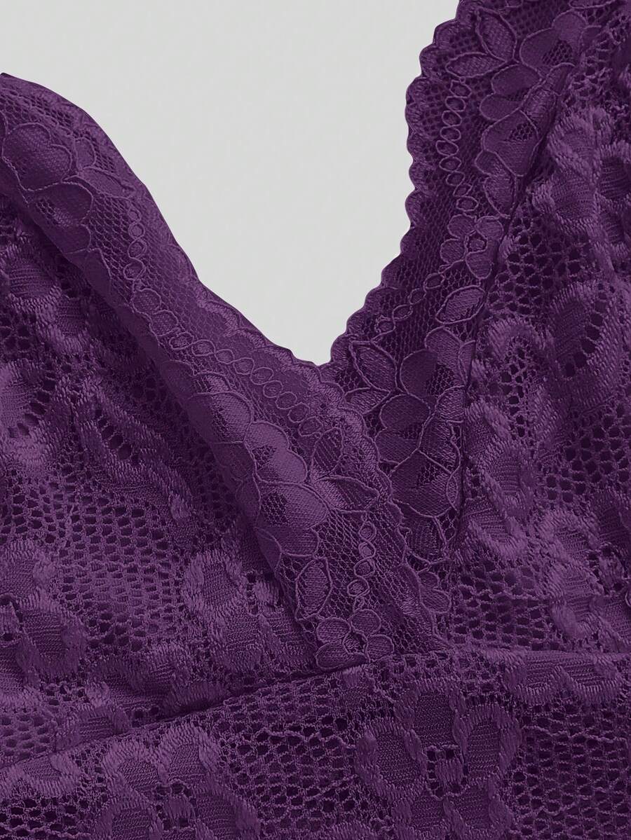 Women's black lace halter neck camisole featuring a backless crop silhouette, contrast lace trim, and scallop hem.