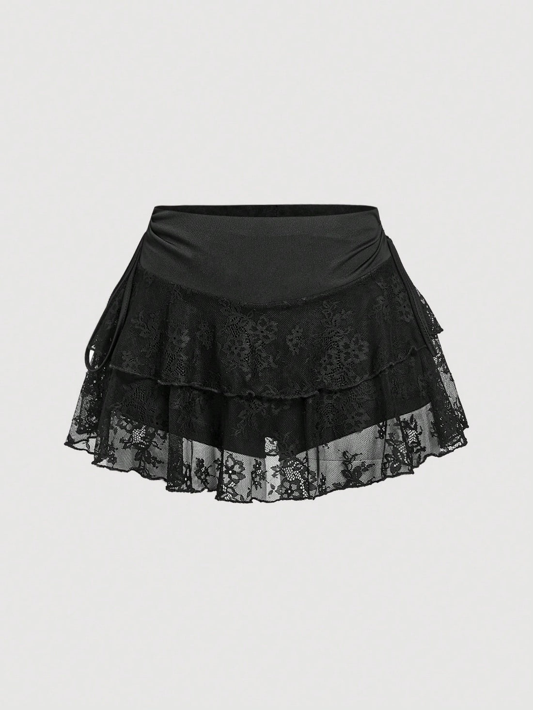 A woman wearing a black lace tiered ruffle mini skirt skort featuring a mid-waist design and layered hemline.
