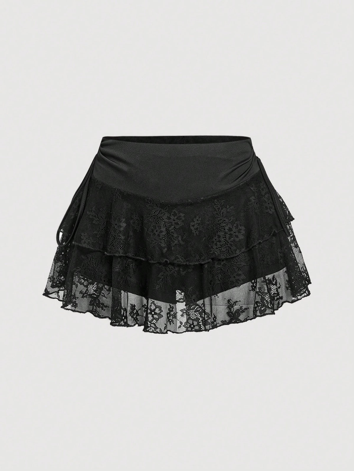 A woman wearing a black lace tiered ruffle mini skirt skort featuring a mid-waist design and layered hemline.