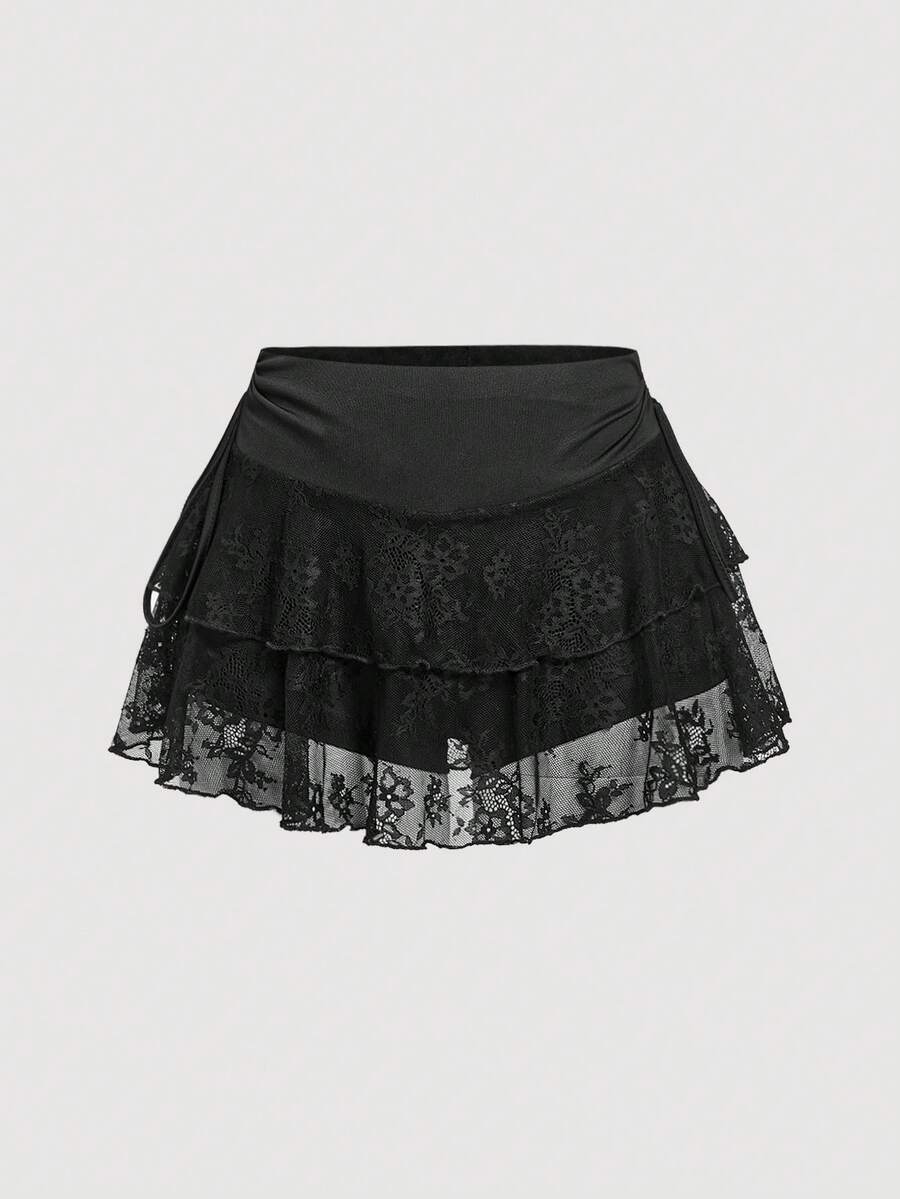 A woman wearing a black lace tiered ruffle mini skirt skort featuring a mid-waist design and layered hemline.
