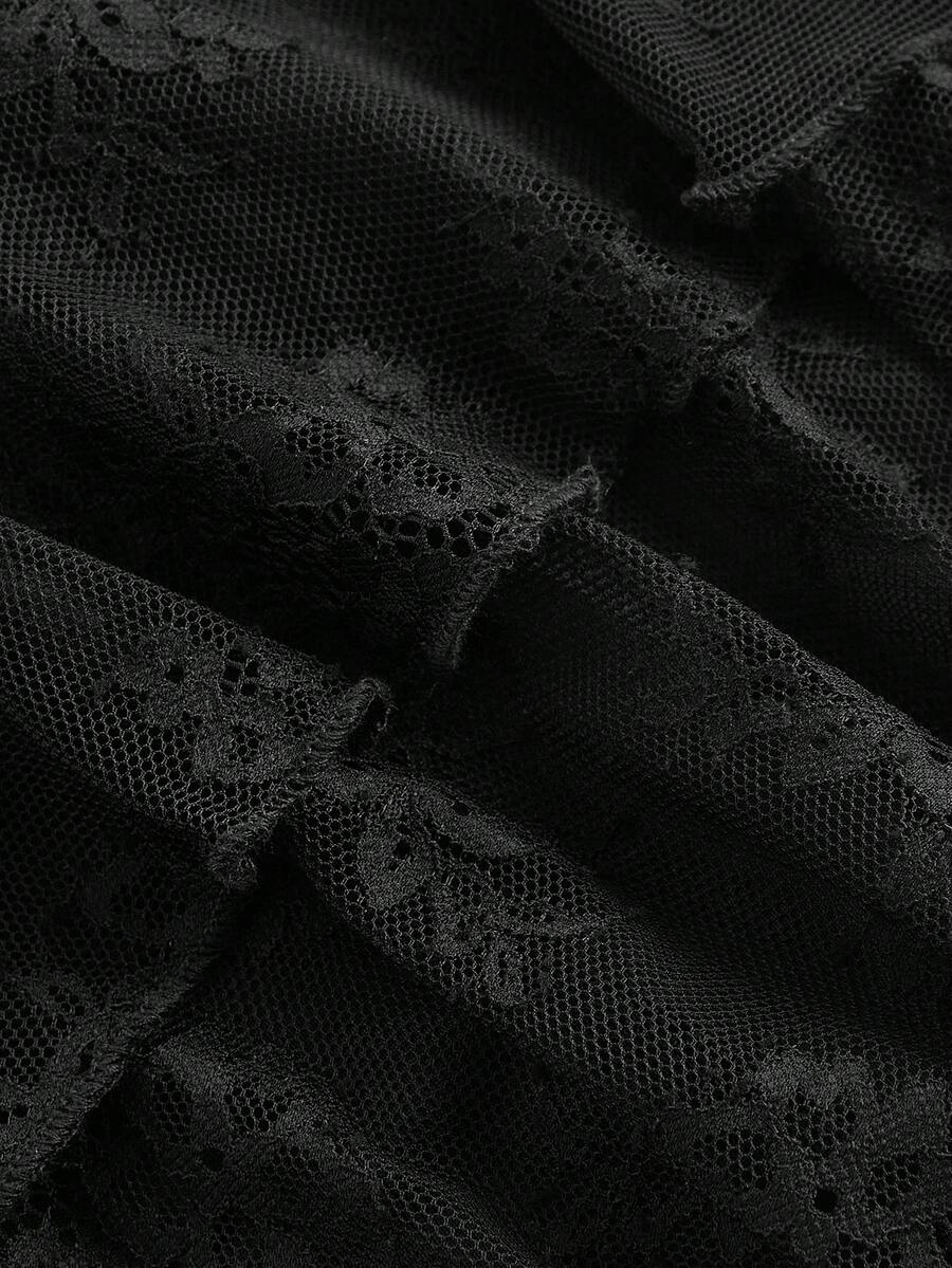 A woman wearing a black lace tiered ruffle mini skirt skort featuring a mid-waist design and layered hemline.