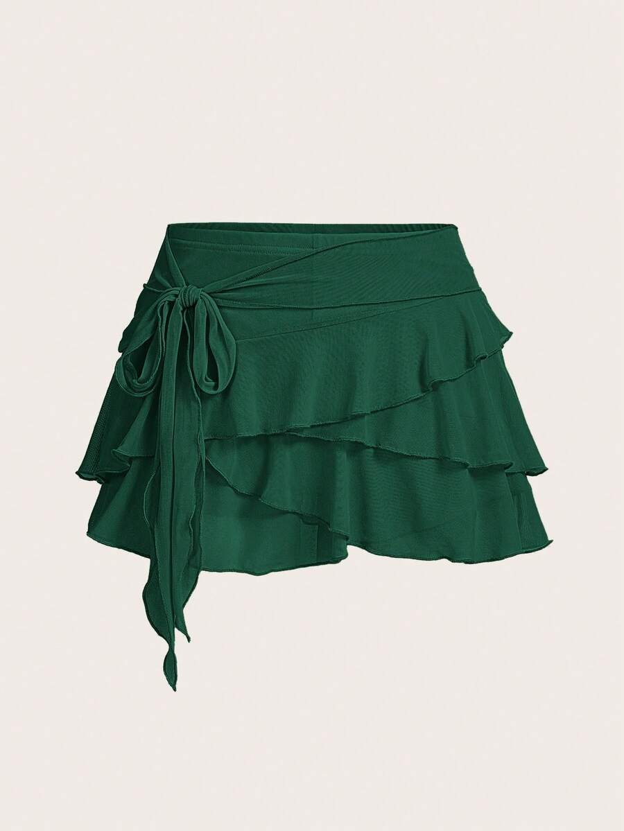 White tiered ruffle trim mini skirt for women with low waist, knot detail, mesh fabric, and casual Y2K boho design.