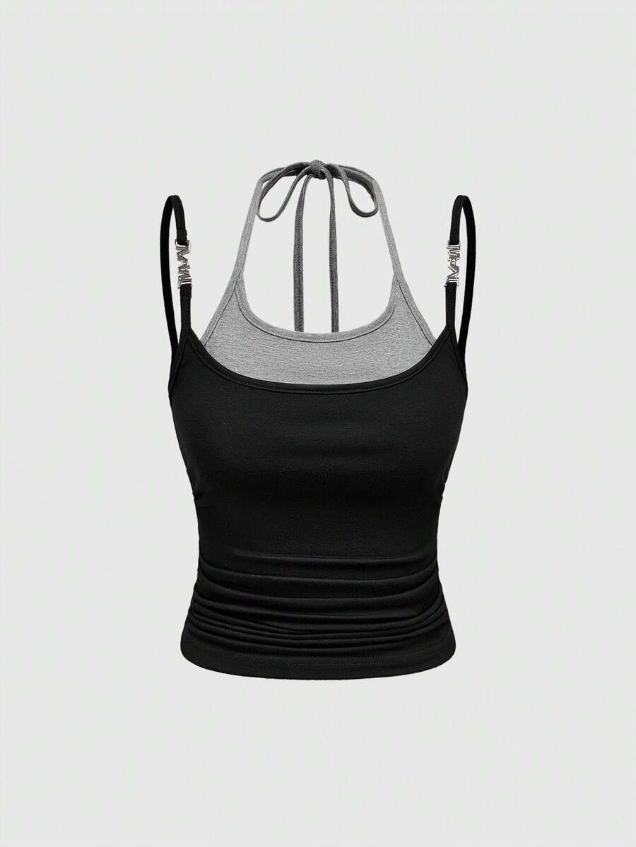 Black halter crop tank top featuring lace-up front details, ruched texture, eye appliques, and matching detached arm sleeves.