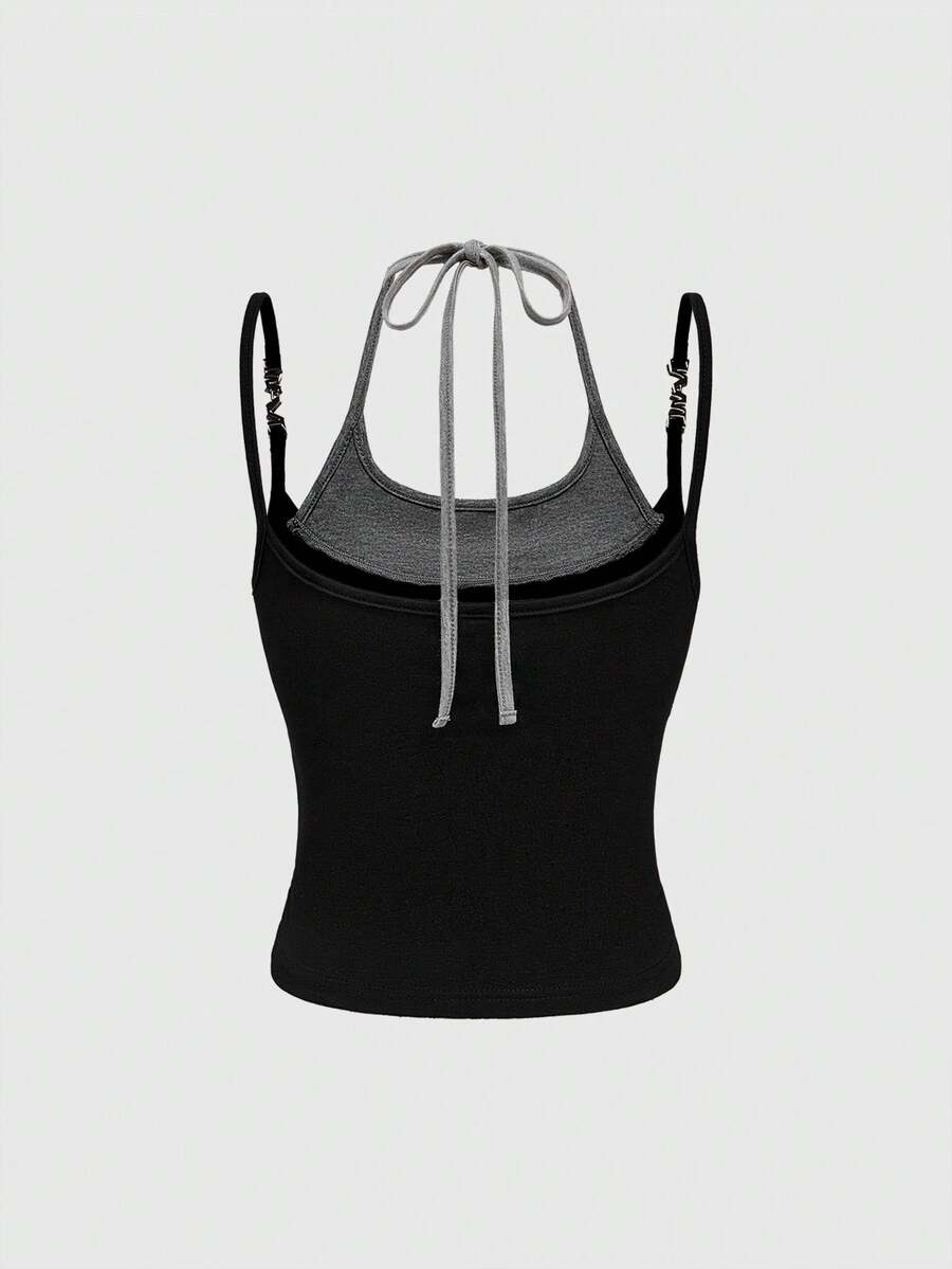 Black halter crop tank top featuring lace-up front details, ruched texture, eye appliques, and matching detached arm sleeves.