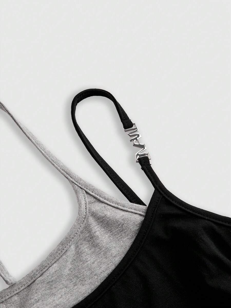 Black halter crop tank top featuring lace-up front details, ruched texture, eye appliques, and matching detached arm sleeves.